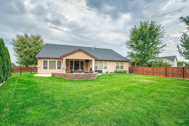 back of house with a patio area and a lawn