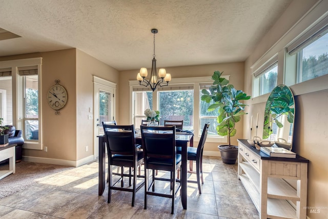 dining area featuring a textured ceiling and an inviting chandelier