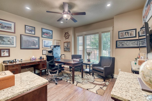 office space with a textured ceiling, light hardwood / wood-style flooring, and ceiling fan