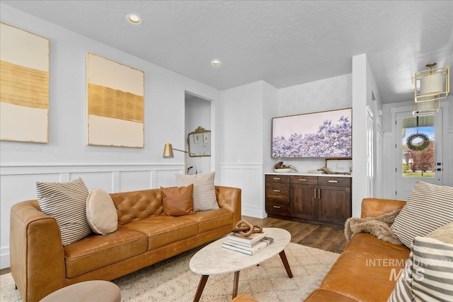 8701 W Suttle Lake Dr, Boise, ID 83714 - living room with dark wood-style floors, a decorative wall, a wainscoted wall, and recessed lighting