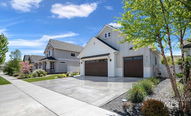 8701 W Suttle Lake Dr, Boise, ID 83714 - view of front of home featuring board and batten siding, driveway, fence, a garage, and brick siding