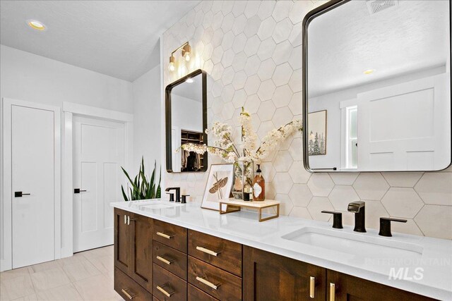 8701 W Suttle Lake Dr, Boise, ID 83714 - bathroom with tasteful backsplash, double vanity, and recessed lighting