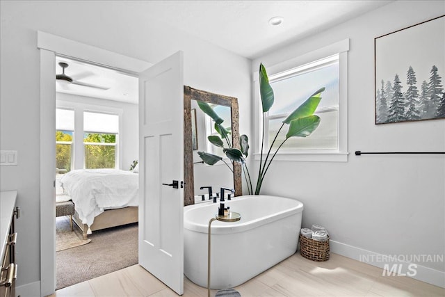 8701 W Suttle Lake Dr, Boise, ID 83714 - ensuite bathroom featuring a freestanding bath and baseboards