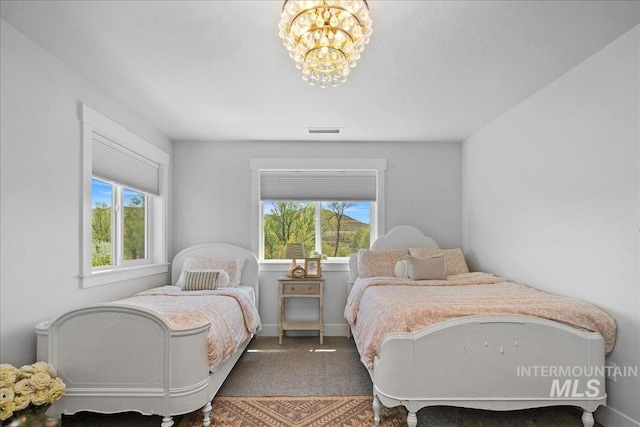 8701 W Suttle Lake Dr, Boise, ID 83714 - carpeted bedroom featuring a chandelier and baseboards