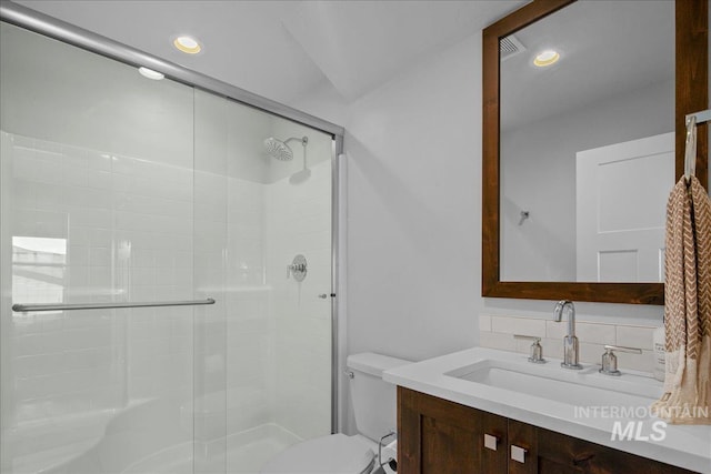8701 W Suttle Lake Dr, Boise, ID 83714 - bathroom featuring decorative backsplash, a shower stall, toilet, vanity, and recessed lighting
