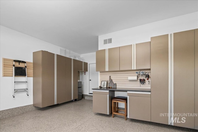 8701 W Suttle Lake Dr, Boise, ID 83714 - kitchen featuring a desk, dark countertops, and dark speckled floor