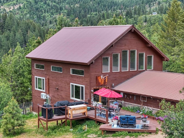 27 Park Ln, Boise, ID 83716 - back of property featuring a wooded view, a deck, and a metal roof
