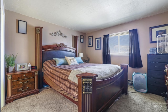 carpeted bedroom featuring a textured ceiling