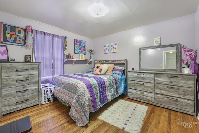 bedroom with wood finished floors