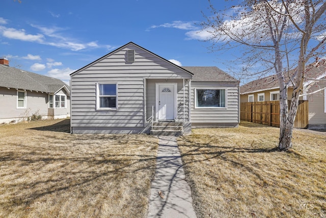 view of front of property with a front yard and fence