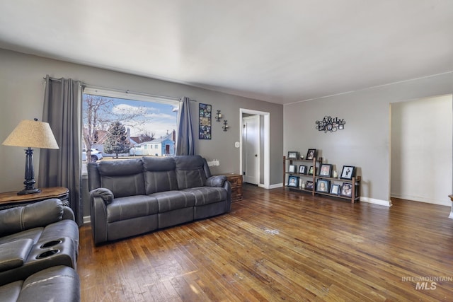 living room featuring hardwood / wood-style floors and baseboards