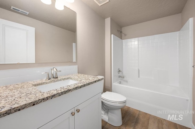 17785 N Onaway Ave, Nampa, ID 83687 - full bath featuring wood finished floors, vanity, toilet, bathing tub / shower combination, and tasteful backsplash