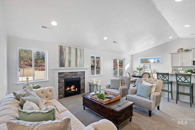 17785 N Onaway Ave, Nampa, ID 83687 - living area with light colored carpet, lofted ceiling, a warm lit fireplace, and recessed lighting
