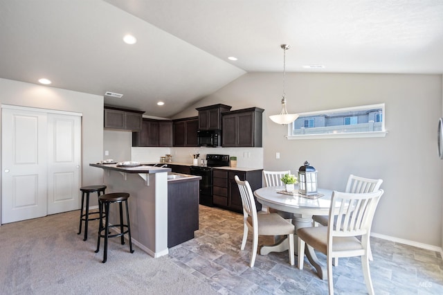 17785 N Onaway Ave, Nampa, ID 83687 - kitchen featuring black appliances, dark brown cabinetry, lofted ceiling, a kitchen breakfast bar, and a kitchen island