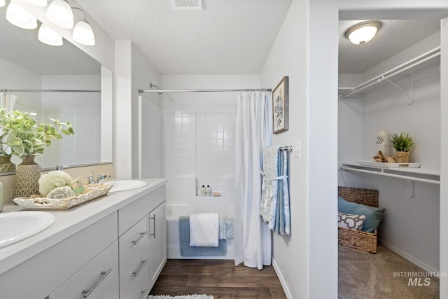 17785 N Onaway Ave, Nampa, ID 83687 - full bath with shower / bath combo with shower curtain, double vanity, baseboards, and wood finished floors