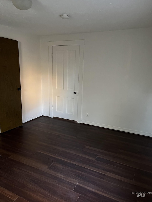 empty room featuring dark hardwood / wood-style flooring