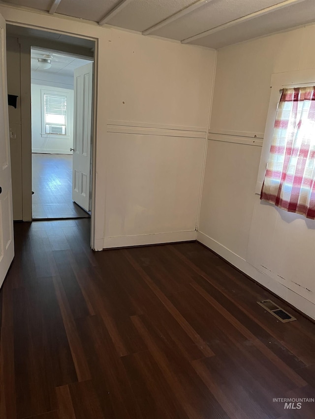 unfurnished room featuring dark hardwood / wood-style floors