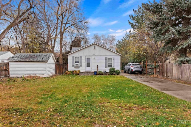 view of front facade with a storage unit and a front lawn