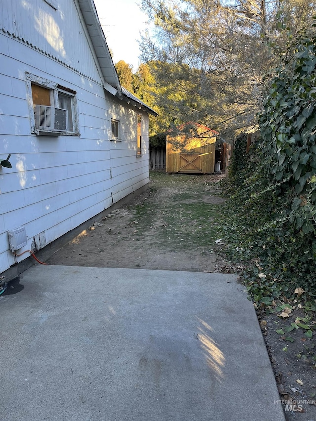 view of side of property featuring cooling unit and a patio