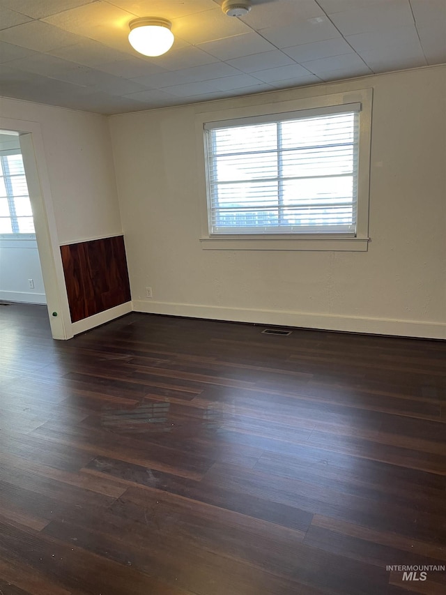 empty room with dark hardwood / wood-style flooring