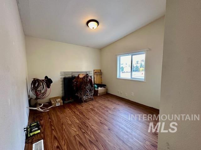 interior space with vaulted ceiling and hardwood / wood-style flooring