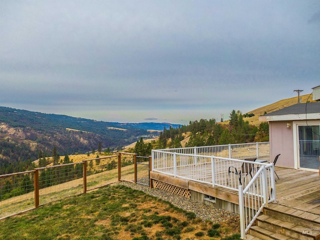 view of yard featuring a deck with mountain view