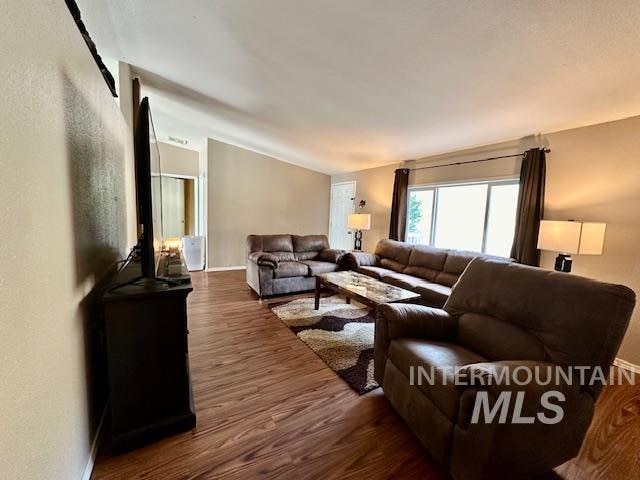 living room with dark hardwood / wood-style flooring