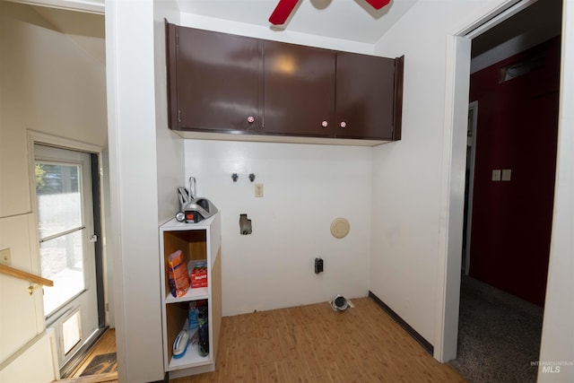 washroom featuring cabinet space, light wood-style flooring, a ceiling fan, and washer hookup