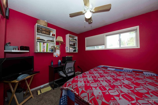 bedroom with carpet, an office area, and a ceiling fan