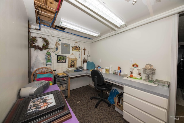 home office with built in study area and carpet