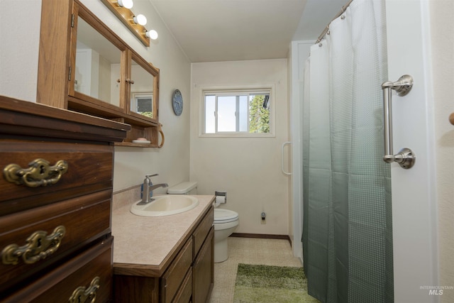 bathroom featuring toilet, vanity, a shower with shower curtain, tile patterned floors, and baseboards