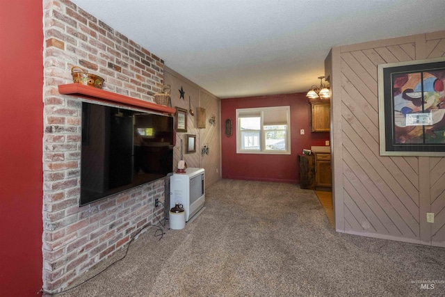 unfurnished living room with carpet flooring and wood walls