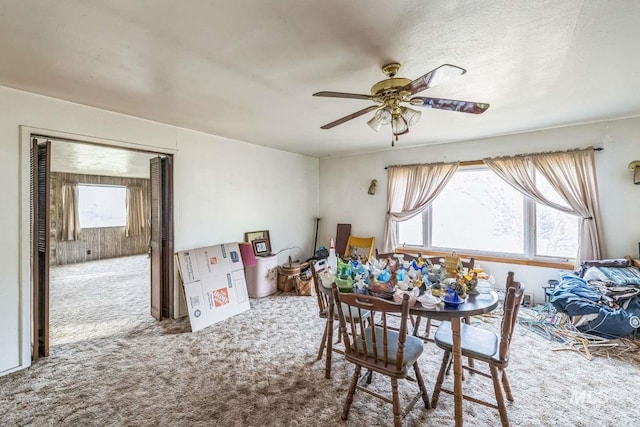 dining area with carpet flooring, plenty of natural light, and ceiling fan