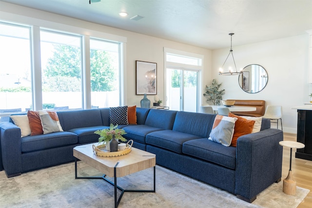 1946 W Windswept, Meridian, ID 83646 - living area featuring light wood-style flooring, a chandelier, and recessed lighting