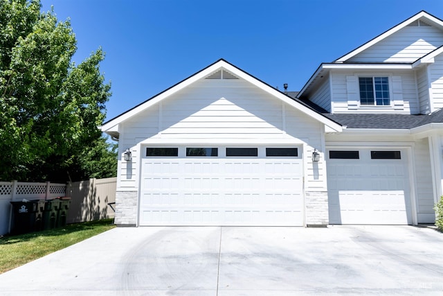 1946 W Windswept, Meridian, ID 83646 - view of front of home featuring stone siding, concrete driveway, roof with shingles, and a garage