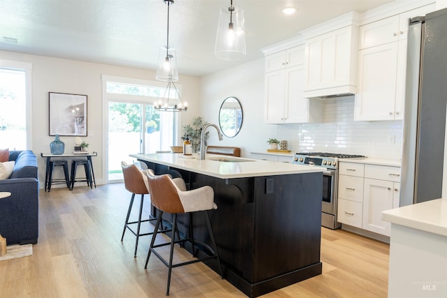 1946 W Windswept, Meridian, ID 83646 - kitchen with appliances with stainless steel finishes, light wood finished floors, light countertops, decorative backsplash, and recessed lighting