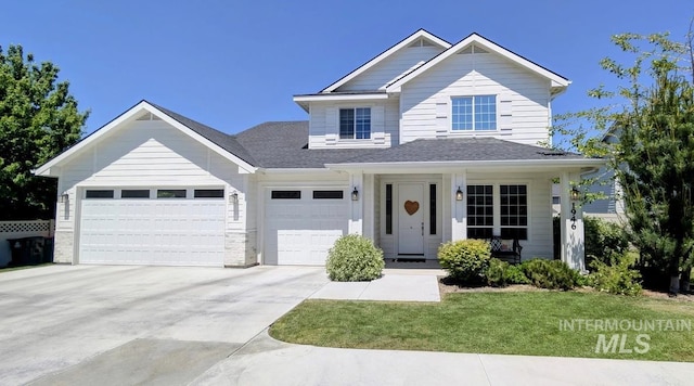 1946 W Windswept, Meridian, ID 83646 - view of front of home featuring concrete driveway, an attached garage, a front yard, a porch, and a shingled roof