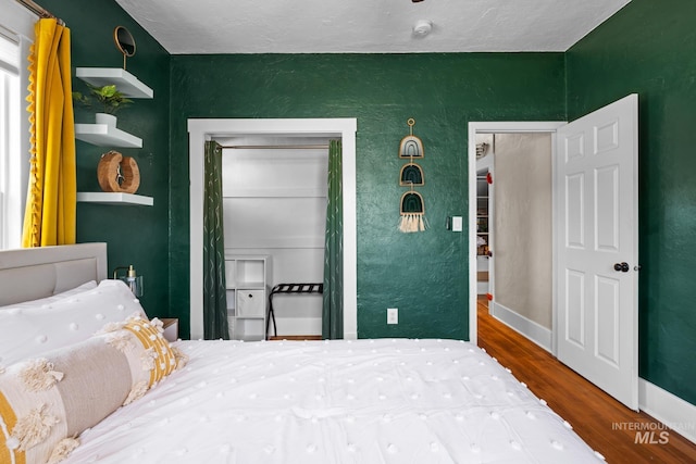 4705 W Franklin Rd, Boise, ID 83705 - bedroom with wood finished floors and a textured wall