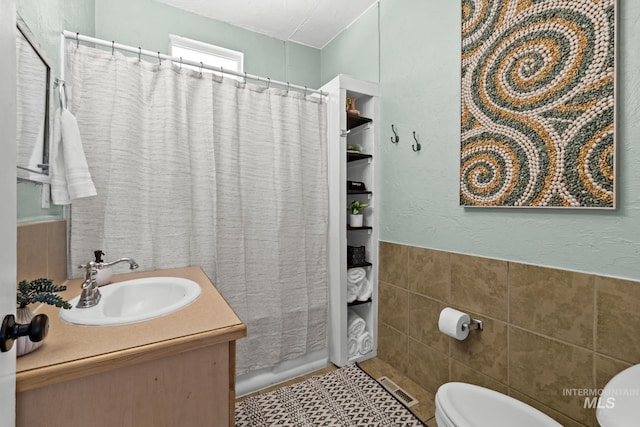 4705 W Franklin Rd, Boise, ID 83705 - full bathroom with tile walls, vanity, a shower with curtain, tile patterned flooring, and wainscoting
