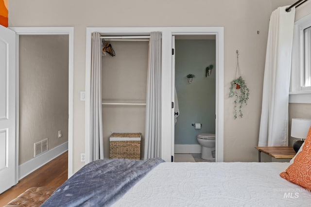 4705 W Franklin Rd, Boise, ID 83705 - bedroom with wood finished floors, a closet, and ensuite bath