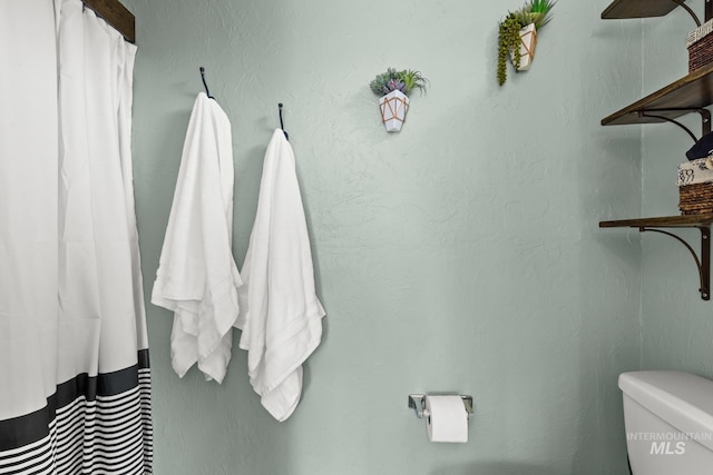 4705 W Franklin Rd, Boise, ID 83705 - bathroom featuring toilet and a shower with shower curtain