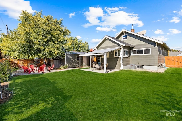 4705 W Franklin Rd, Boise, ID 83705 - rear view of property featuring a patio, a fenced backyard, a fire pit, and a chimney