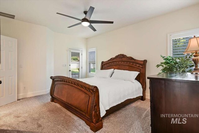 bedroom featuring access to exterior, visible vents, a ceiling fan, light carpet, and baseboards