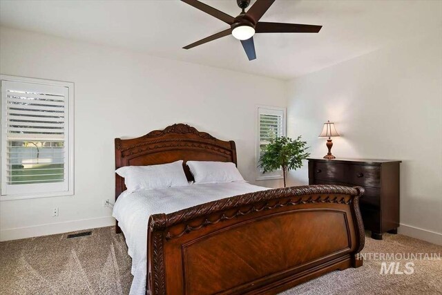 bedroom featuring carpet floors, visible vents, baseboards, and a ceiling fan