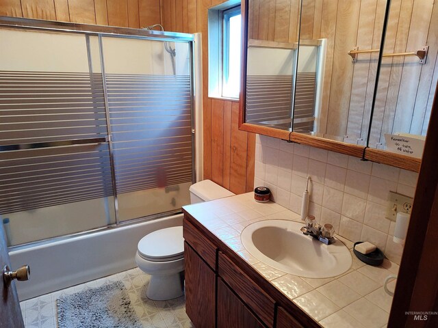 2738 Dixie Rd, Dixie, ID 83525 - full bathroom with backsplash, vanity, toilet, shower / bath combination with glass door, and wood walls