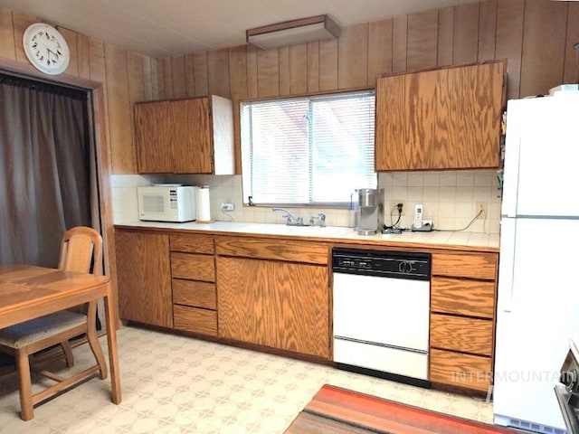 2738 Dixie Rd, Dixie, ID 83525 - kitchen with white appliances, tile countertops, a sink, light flooring, and wooden walls