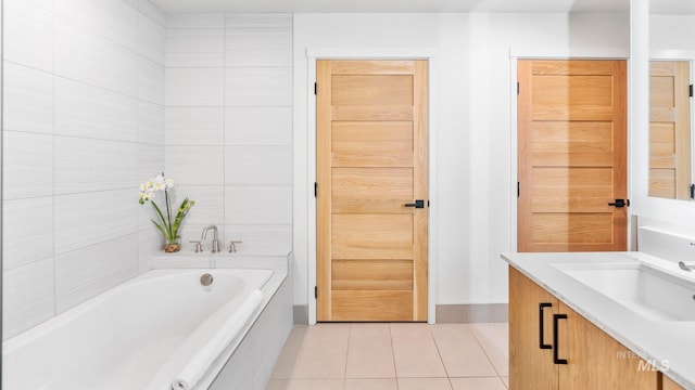 bathroom featuring vanity, tile patterned floors, and tiled bath