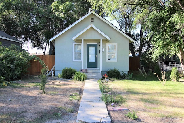 bungalow-style house with a front lawn