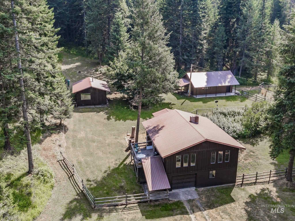 birds eye view of property with a view of trees