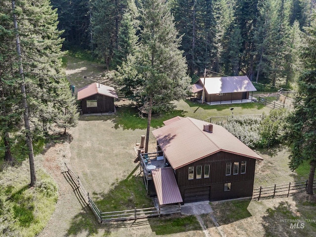 birds eye view of property with a view of trees